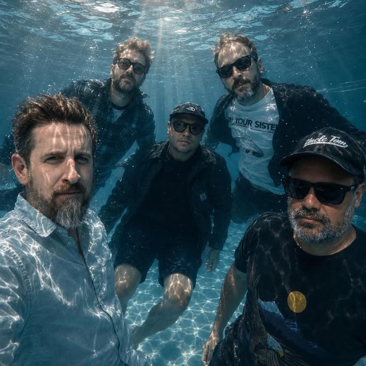 The five members of Fat Skeleton posing underwater